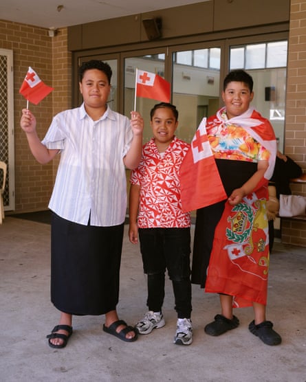 Three young members of the Tongan congregation fly their flags at Sunday worship