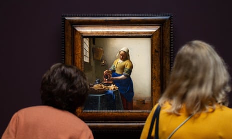 Two women look at The Milkmaid by Vermeer