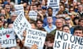 A sea of faces interspersed with banners saying: 'No to racist intimidation', 'Asylum is a human right', 'Migration is not a crime' and 'No one is illegal'