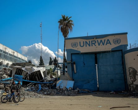 People walk past the damaged Gaza City headquarters of Unrwa in February 2024.
