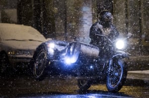 Seattle, Washington: A motorcycle rider in snow