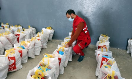 A Red Crescent worker prepares food packages to be delivered to elderly and needy families in Tunisia