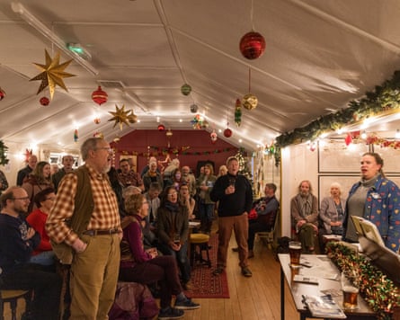 Decorated village hall with people ready to sing