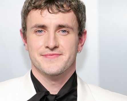 Paul Mescal, wearing a white suit, black shirt and silver earring at 2026 Vanity Fair Oscar Party, 15 March 2026 in Los Angeles, California.