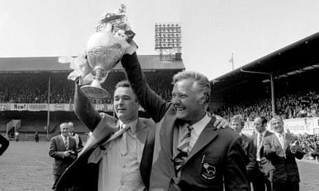 Derby County manager Brian Clough (left) and his assistant Peter Taylor show off the League Championship trophy to jubilant Derby fans in 1972.