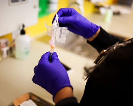 A medical assistant prepares a flu vaccine.