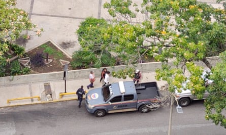 Aerial image of a handful of people near a police vehicle on a residential street
