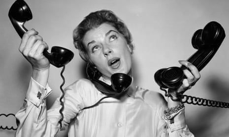 Black and white image of woman trying to answer three telephones at once