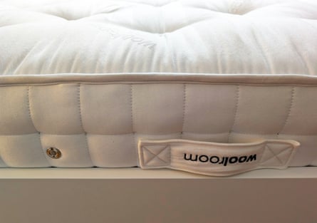 Closeup of the corner of the mattress sitting on a bed frame