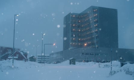 Multistory building in snow at dusk