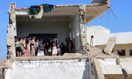 Yemeni students gather inside a class at their school, which was recently hit by a Saudi-led air strike.
