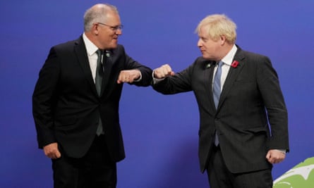 Scott Morrison and Boris Johnson bump elbows at a meeting in front of a purple background