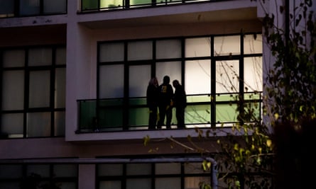 The silhouettes of people standing on a balcony.