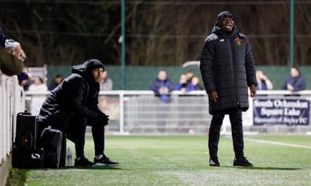 George Elokobi tries to get instructions to his team as his assistant, Craig Fagan, looks on.