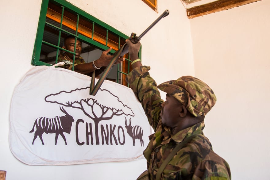 Dieudonné, a ranger, returns from patrol and hands his weapon over to senior ranger Saint-Cyr in Chinko’s armoury.
