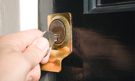 Person putting key in keyhole