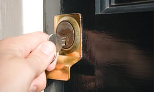 Person putting key in keyhole
