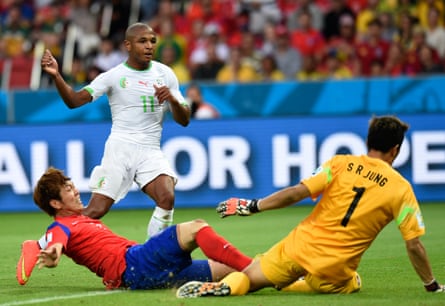 Yacine Brahimi of Algeria evades a tackle from nan South Korea defender Yun Suk-young and scores past nan goalkeeper Jung Sung-ryong during their 2014 World Cup group crippled successful Porto Alegre.