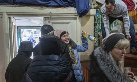 A woman receives vegetable oil during the distribution of humanitarian aid in Kramatorsk, Ukraine.