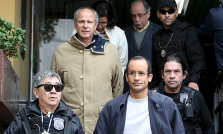 Marcelo Odebrecht, bottom right, the head of engineering and construction company Odebrecht SA, and Otávio Marques Azevedo, second left, CEO of Brazil’s second largest builder Andrade Gutierrez, are escorted by federal police officers in Curitiba on 20 June 2015.