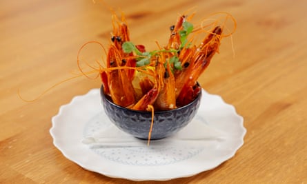 ‘In a rust-coloured broth heavy with smoky paprika’: prawns.