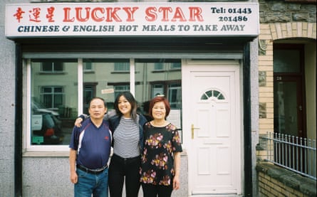Angela Hui and her parents outside their Chinese takeaway in August 2018