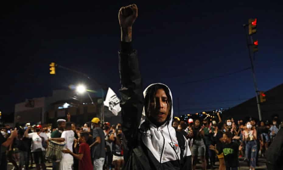 A man raises his fist during a protest against the death of Joao Alberto Silveira Freitas in Porto Alegre, Brazil on Monday.