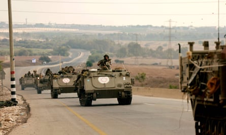 Israeli soldiers ride in armoured vehicles