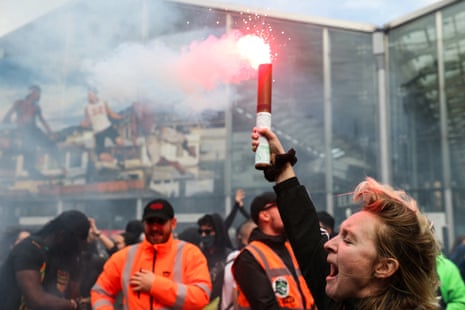 Protesters hold smoke flares and chant slogans as they demonstrate in front of the Gare du Nord train station in Paris, on Wednesday during the ‘block everything’ protest movement.