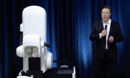 elon musk with the surgical robot from his august 2020 neuralink presentation