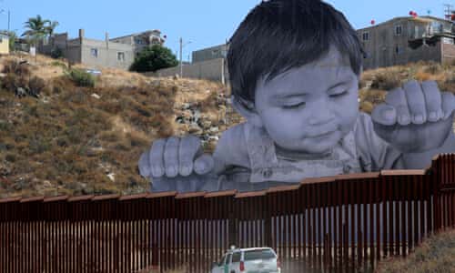 Meet the baby whose huge image gazes over the border
