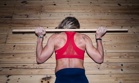 ‘Draw the stick down your back behind your head as far as you can.’