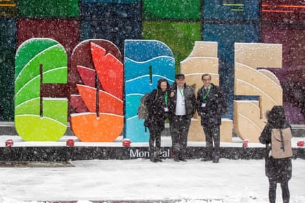 People pose in front of letters spelling out Cop15.
