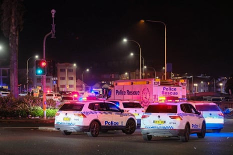Police cars are seen parked at at the scene of a mass shooting at Bondi Beach in on December 14, 2025 in Sydney, Australia.