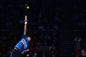 Novak Djokovic serves.