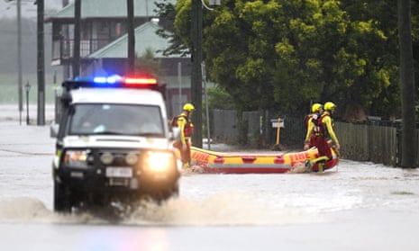 A rescue crew make their way through flood water on Friday in Laidley, Australia