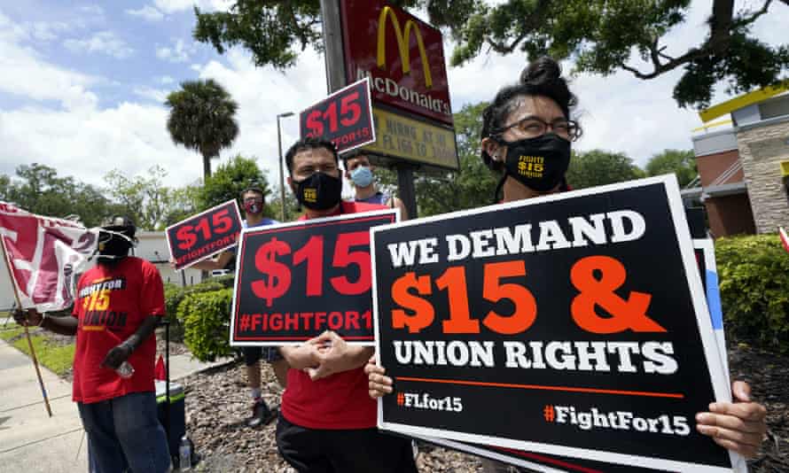 McDonald's workers and labor activists protest to demand the company pays at least $15 an hour