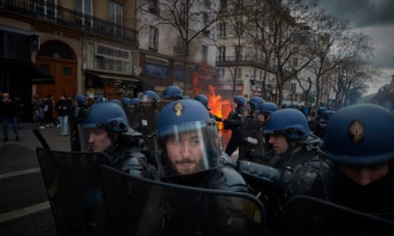 Riot police face protesters during violent clashes in Paris on Thursday.