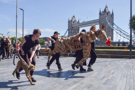 Puppeteers take the animals for a run near Tower Bridge on Friday morning before heading to the West End.