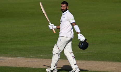 Cheteshwar Pujara raises his bat
