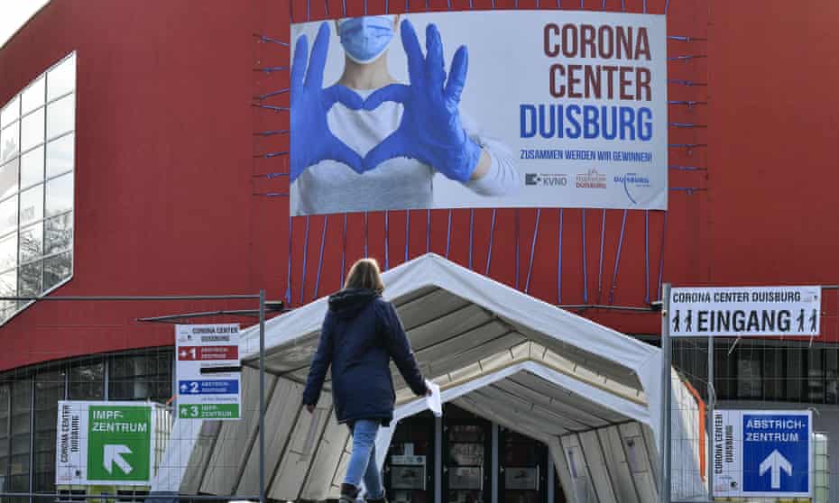 A woman approaches a concert hall repurposed as a vaccination centre in the city of Duisberg