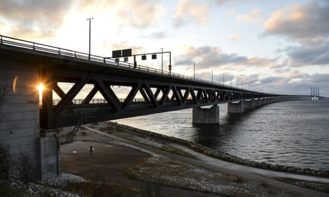 The sun sets over the Oresund Bridge between Sweden and Denmark as national border controls are re-introduced in both countries.