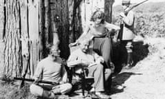 Albert Einstein with his secretary B Howard, Oliver Locker-Lampson and an armed guard outside the hut in 1933.