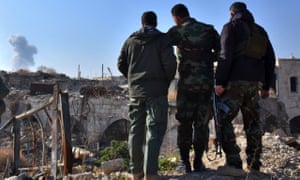 Syrian pro-government forces watch as smoke billows from an airstrike on Aleppo.