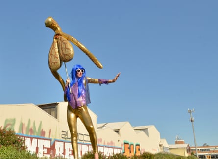 Sydney artist Alli Sebastian Wolf holds up her Glitoris, a giant, gold clitoris devised by the to highlight lack of understanding in the female anatomy.