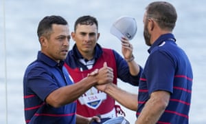 Xander Schauffele and Dustin Johnson shake hands after winning.