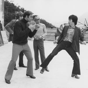 Bruce Lee and John Saxon, with producer Raymond Chow, on the set of the Enter the Dragon in 1973