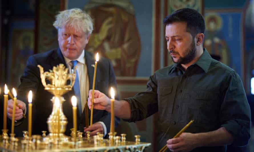 Russia-Ukraine war: Boris Johnson promises to give Ukraine ‘strategic endurance’ to prevail; Putin calls sanctions ‘reckless’ – live 6 The pair lighting candles at Mykhaylo Golden Doms cathedral.