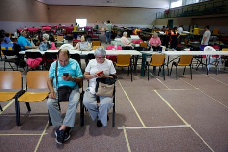 Residents of the towns affected by the wildfires in the western mountains of Madrid rest in a gym in Villamanta, near the capital, after evacuating their homes.