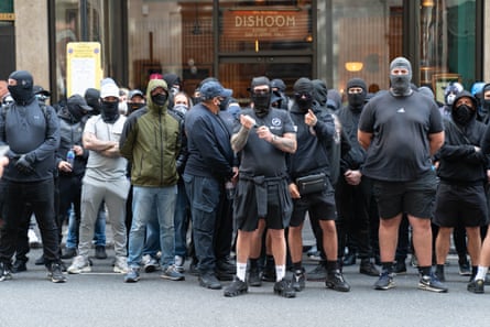 Black-clad men in balaclavas outside the offices of the Daily Mail